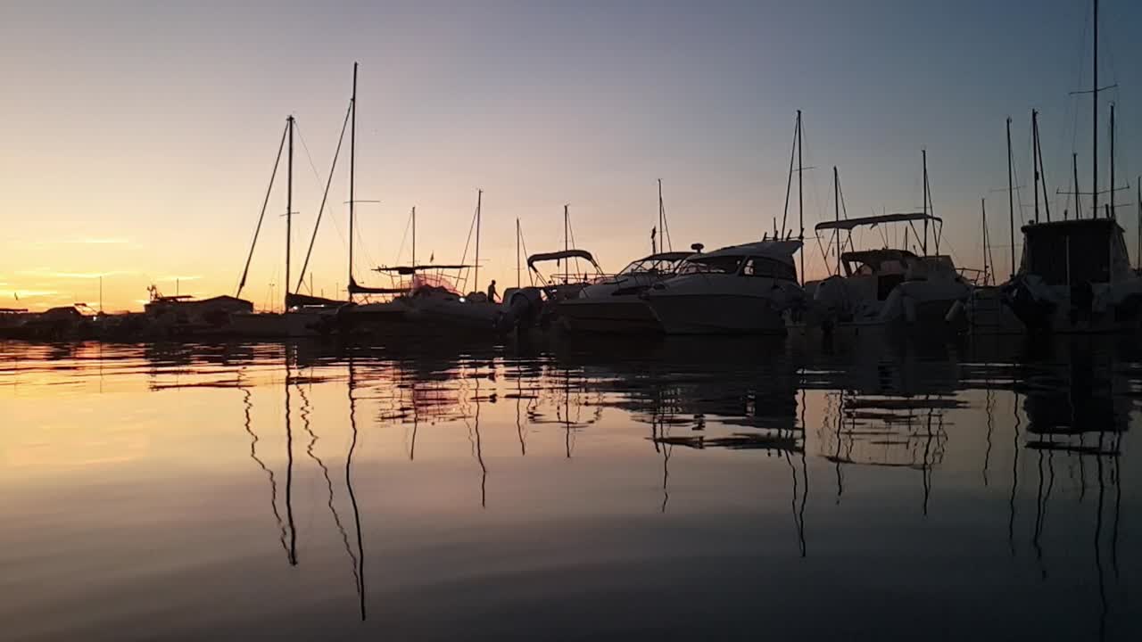Marina Sveva touristic port at sunset. Slow-motion