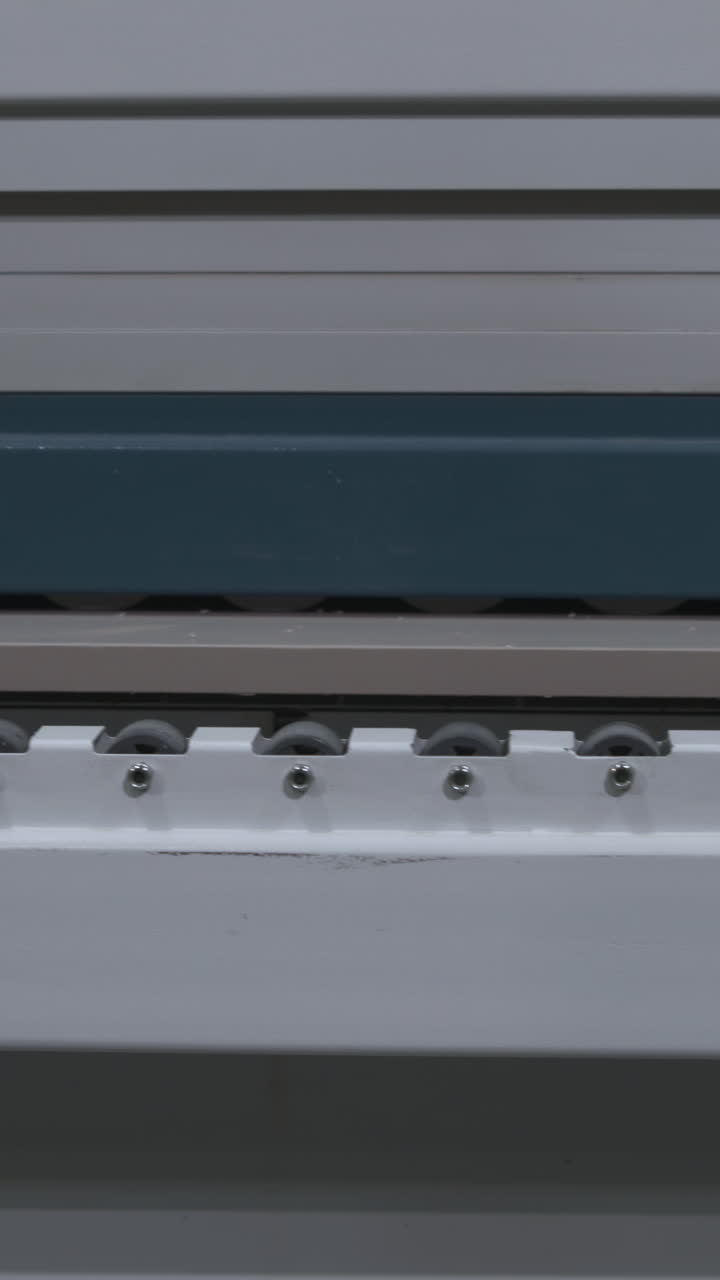 Flat Panel Sliding Across Conveyor Rollers In Workshop Precision Transfer On White Roller Track With Blue. Media
