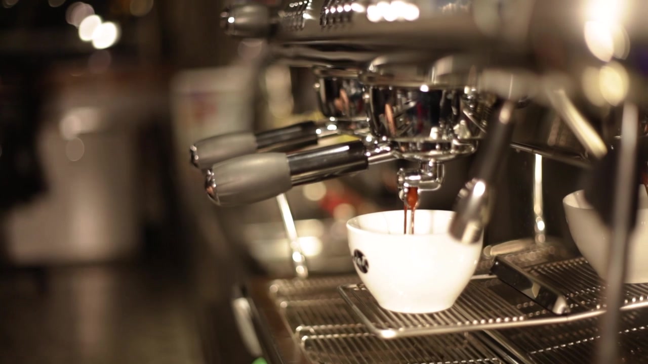 Barista is making a cup of coffee.