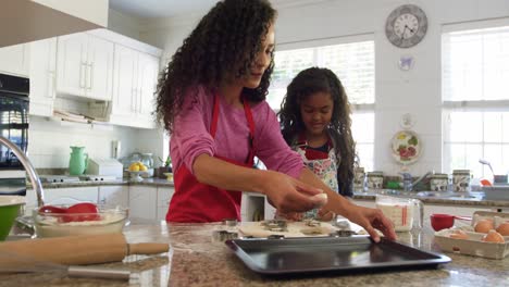 family making christmas cookies at home