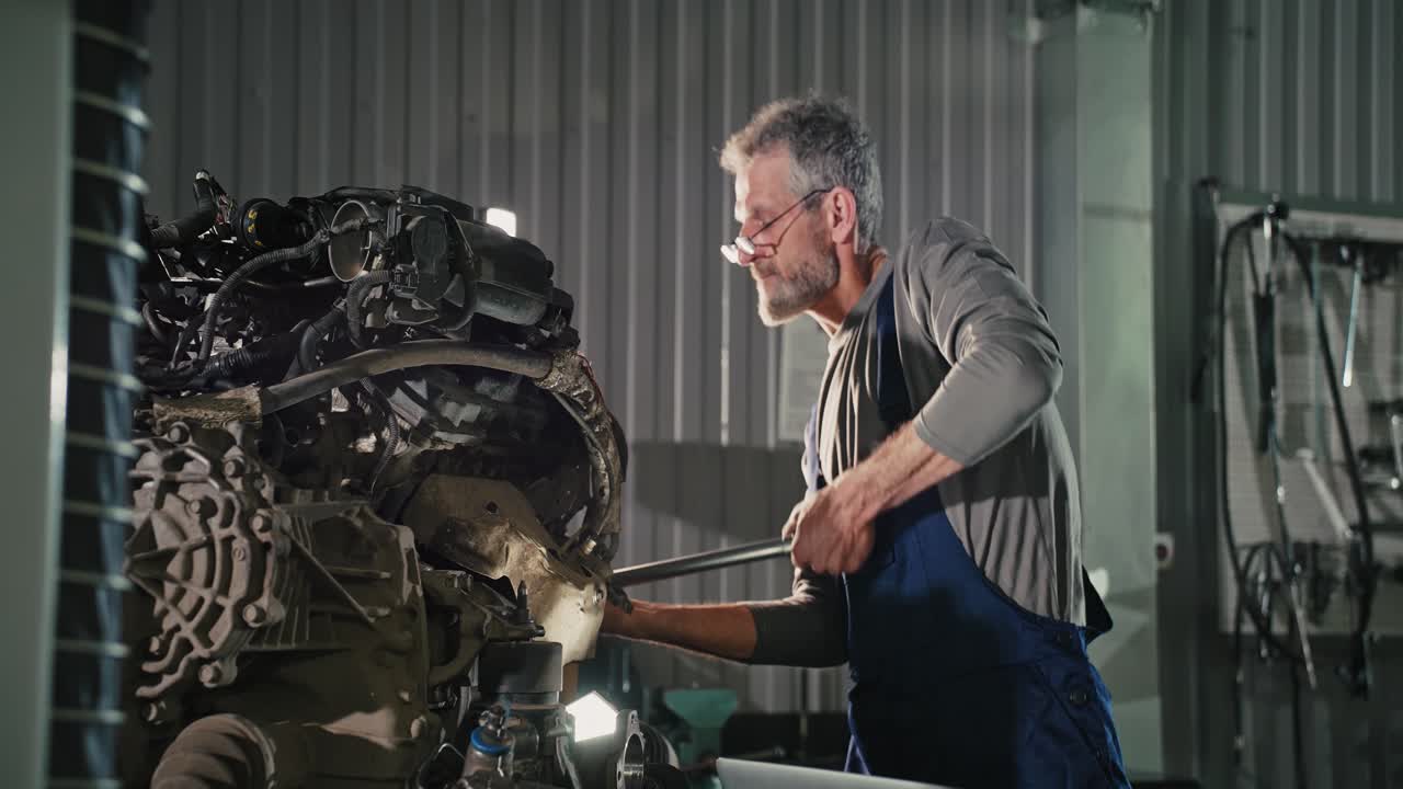 Auto Mechanic Working on a Car Engine in a Garage