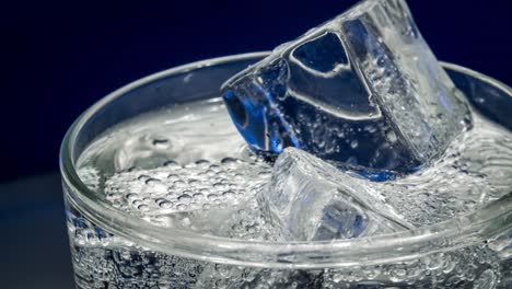 glass of water with ice on a dark blue background