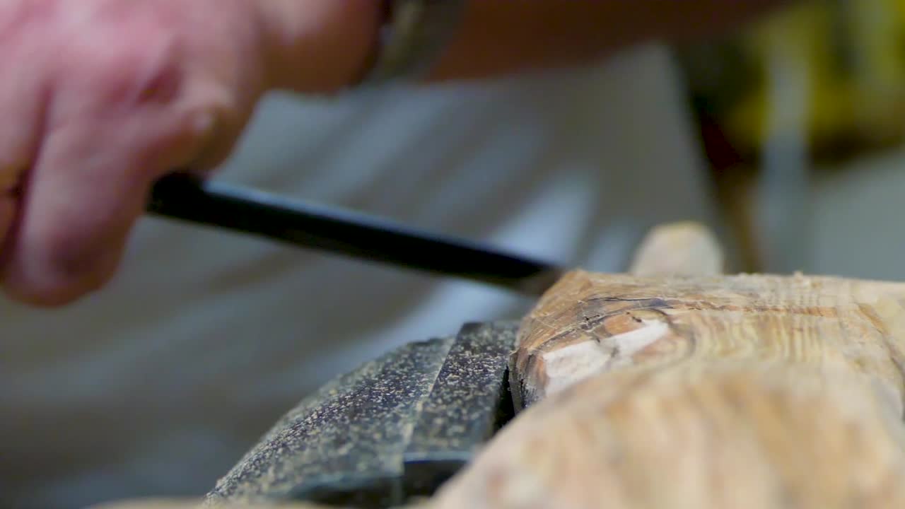 Italian Sculptor in his workshop working on a olive wood statue