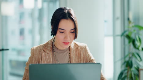 excited businesswoman celebrating success at her laptop