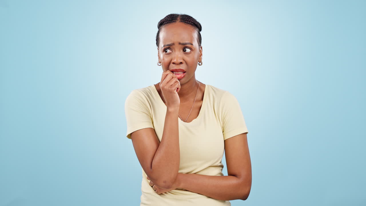 Woman, anxiety and biting nails in studio