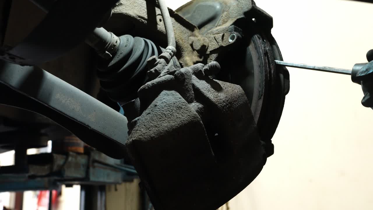 Technician working, vehicle braking system faults, motor industry repairs