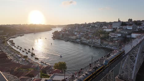 aerial view of porto, portugal at sunset with tram on dom luís i bridge