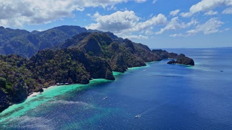 distant drone footage of a long beach on coron island in the philippines