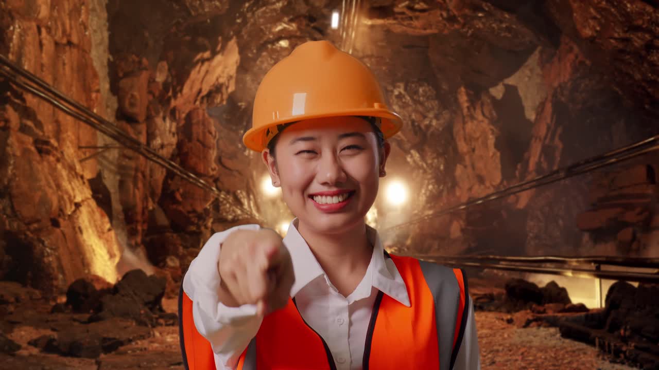 Woman Engineer Pointing in a Mine Tunnel