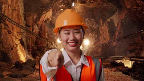 Woman Engineer Pointing in a Mine Tunnel