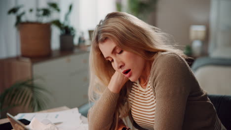 woman working from home, tired and falling asleep at her desk