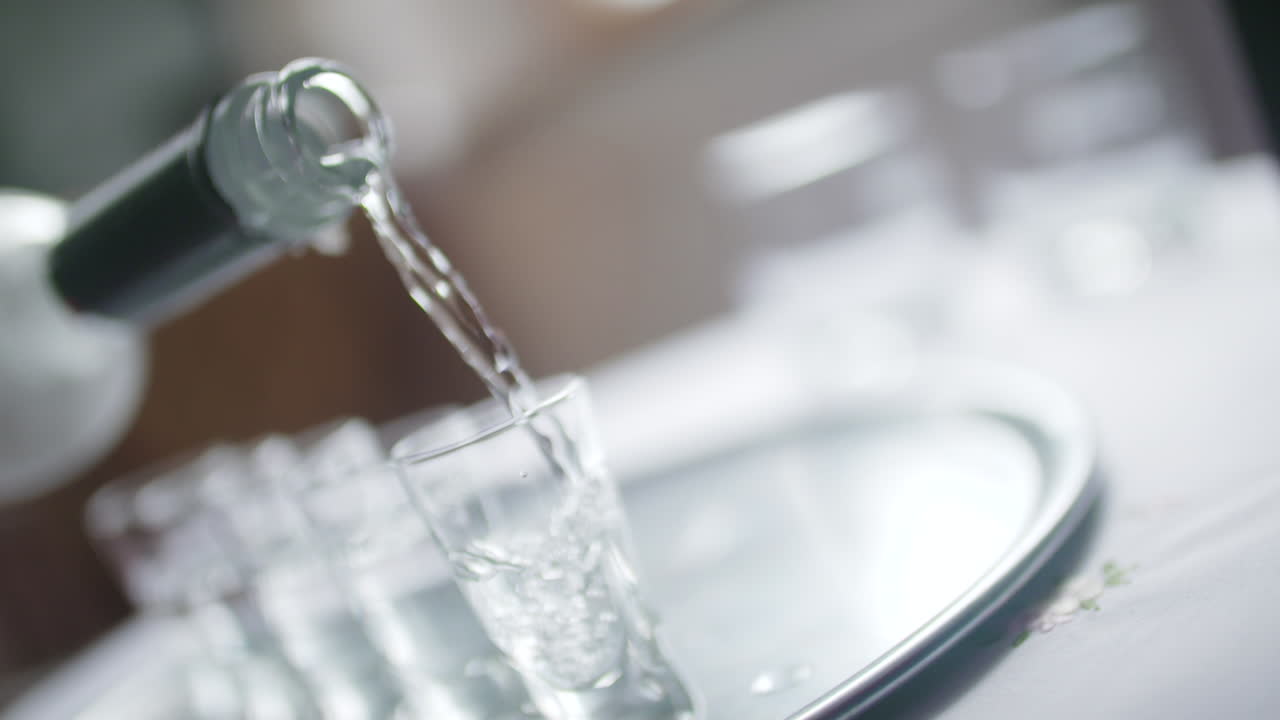 Pouring Vodka into Glasses Close-Up