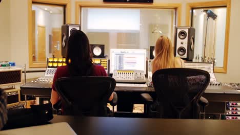 Female-audio-engineers-using-sound-mixer