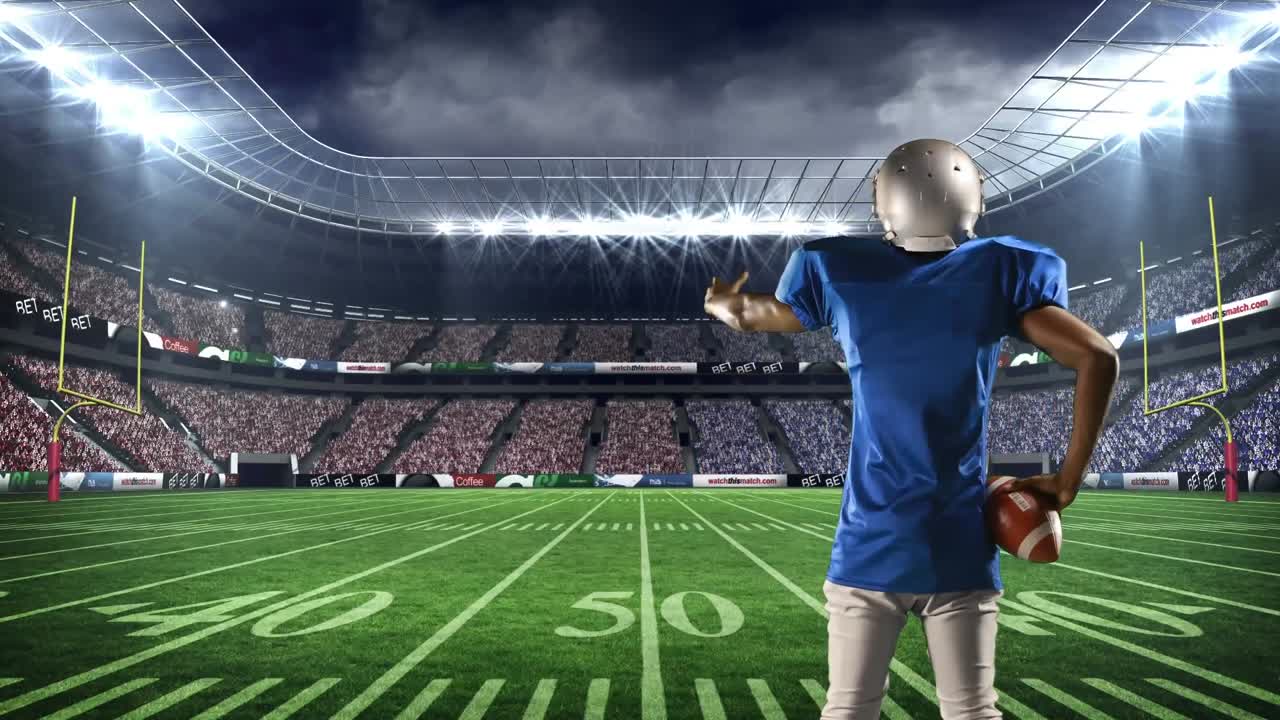 게임 필드에 서 있는 미국 축구 선수