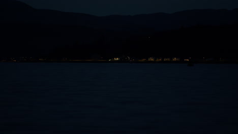 distant lights of seaside town at night