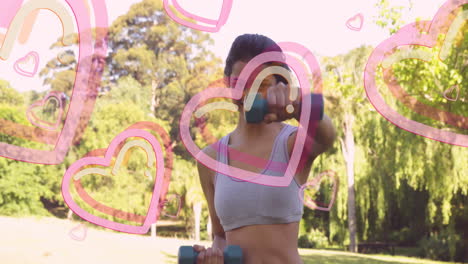 Exercising outdoors with dumbbells, woman surrounded by animation of pink hearts