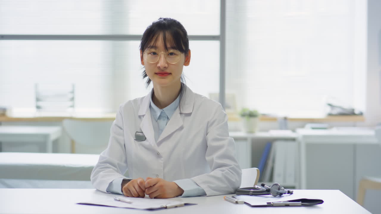Asian Female Doctor Posing at Workplace in Medical Office