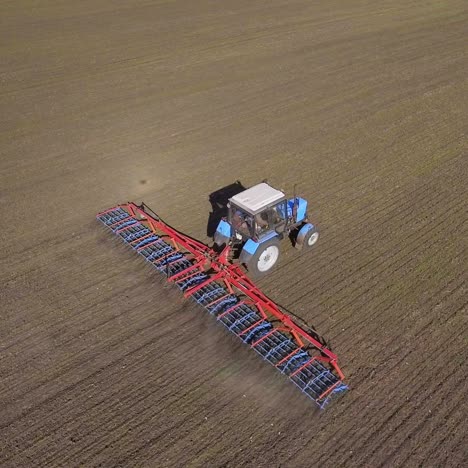 the tractor draws an agricultural device for harrowing the land 4