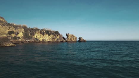 Drone-flying-forward-at-a-rocky-coastline