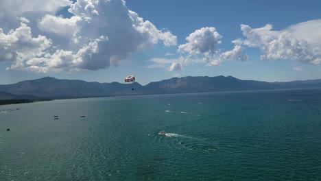 Paragliding-Over-The-Beautiful-Lake-Tahoe-In-California---aerial-drone-shot