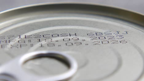 close-up of a can with expiration and best before dates