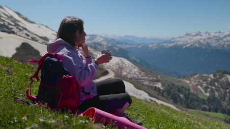 woman enjoying a drink in the mountains