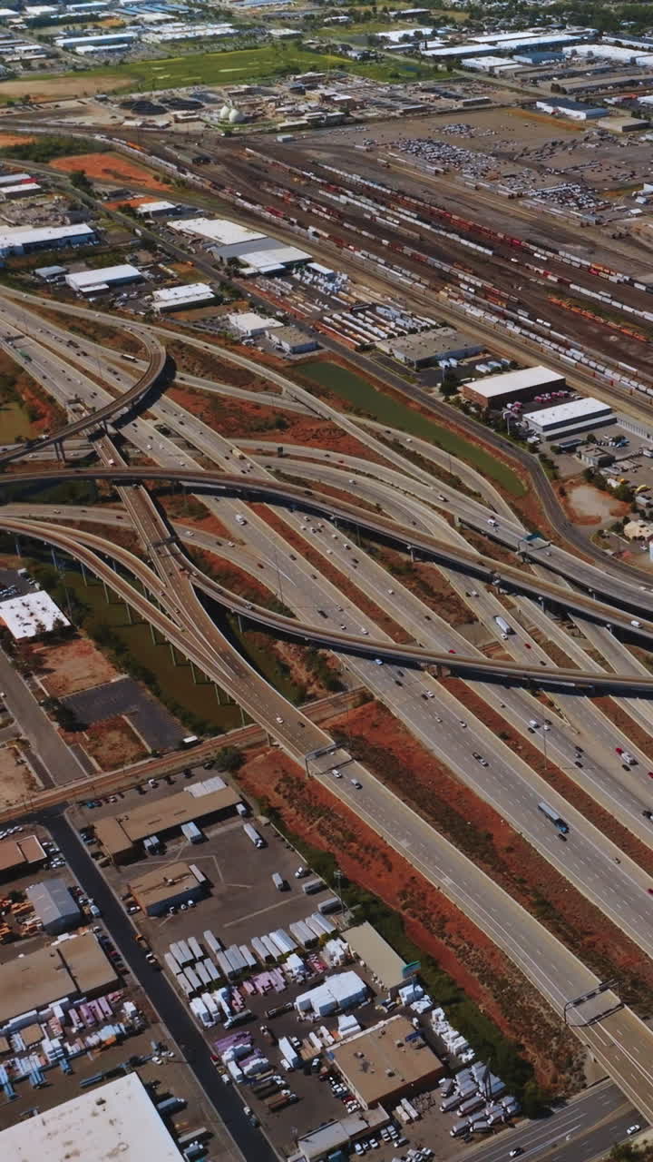 Complexity of highways in Salt Lake City, Utah, USA. Quick traffic on the roads of the metropolis outskirts. Aerial view. Vertical video