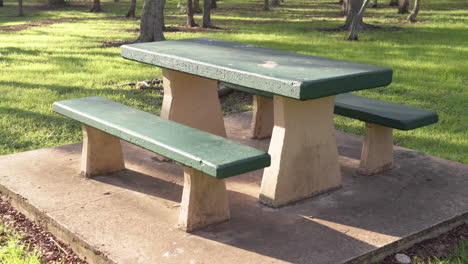 Empty-bench-in-park-with-no-people-in-beautiful-morning-sunlight