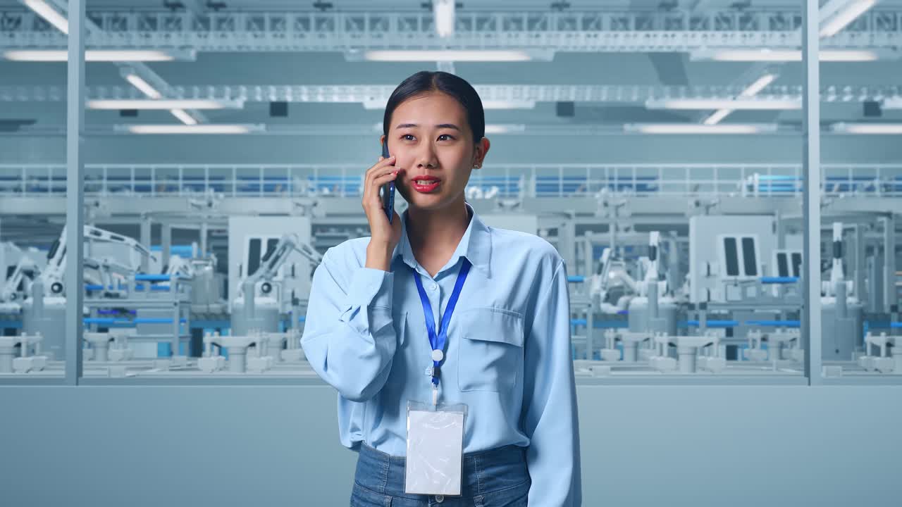 Asian Female Professional Worker Standing at Factory Digitalization for Innovative Project, She Pick The Phone Up And Started To Speaking With It