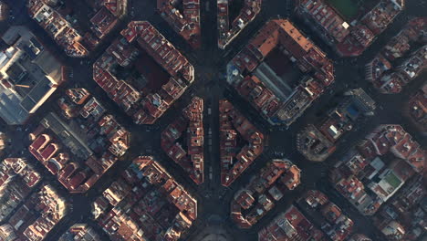 Streets-and-buildings-lit-by-low-sun.-Overhead-view-of-development-in-Eixample-district.-Barcelona,-Spain