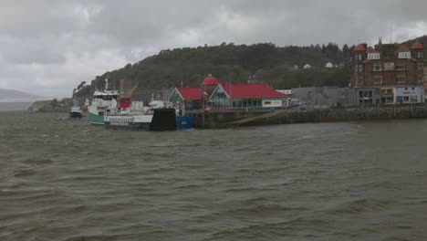 static shot of a small local ferry docked in the oban harbour waiting to sail