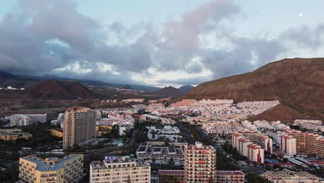 view at popular vacation resorts, buildings, surrounded by mountains on cloudy day