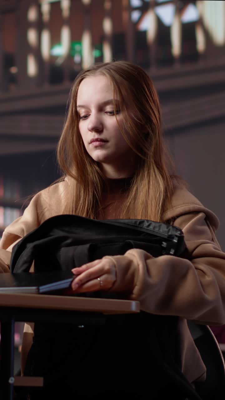 Vertical video college student borrowing books to study for upcoming exams
