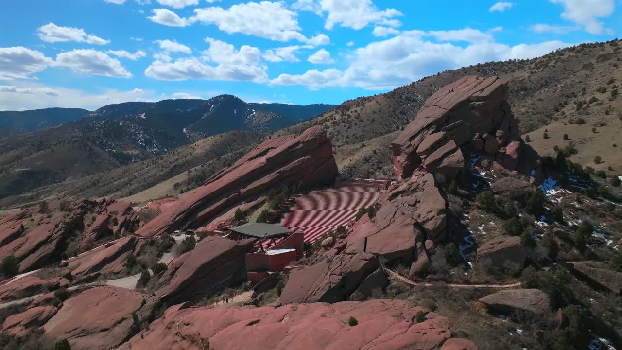 Red Rocks Park and Amphitheater Mount Morrison Colorado aerial drone mid winter music stage snow covered windy walking trails Trading Post sunny blue sky clouds stairs tourist destination upwards