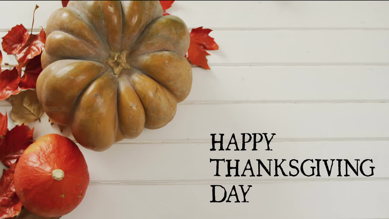 Animation of happy thanksgiving day text over autumn pumpkins on white wooden boards