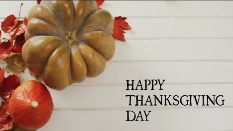 animation of happy thanksgiving day text over autumn pumpkins on white wooden boards