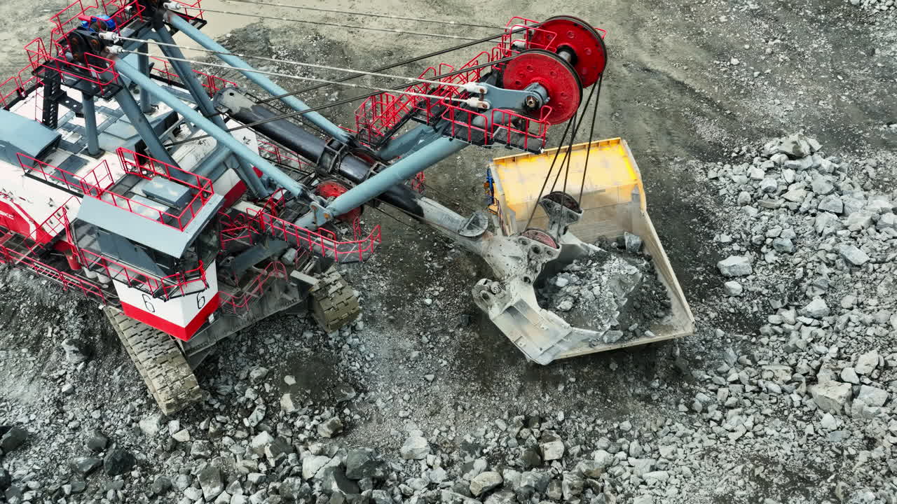 Large Mining Excavator Loading Truck in an Open Pit Mine