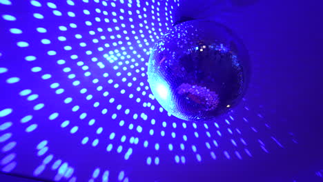 disco ball turning in slowmotion in a night club