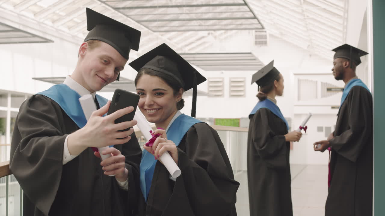 Pair of Happy Multiethnic Graduates Making Selfie