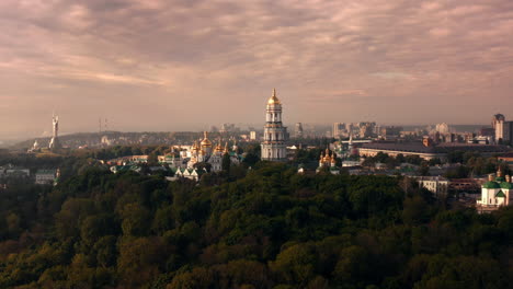 kievan pechersk lavra and kyiv cityscape at sunrise/sunset