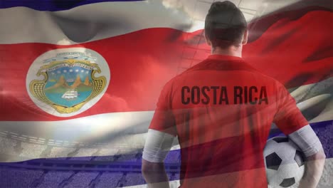 Jugador-De-Fútbol-Con-Bandera-De-Costa-Rica-Sobre-El-Fondo-De-Un-Estadio.