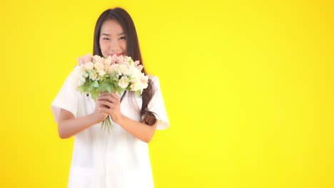 asian female healthcare doctor offering bouquet flowers