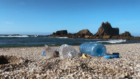 coastal pollution: plastic waste and debris scattered on a sandy beach