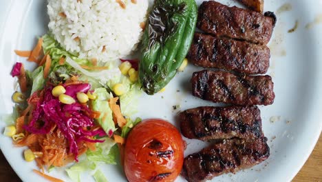 turkish meal with grilled meat, rice, and salad