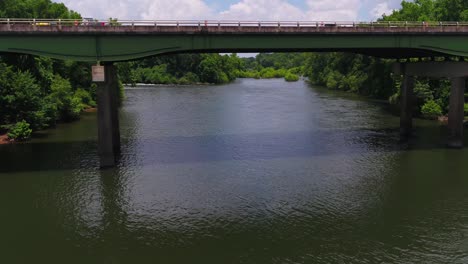 drone flight under a bridge on a river in georgia