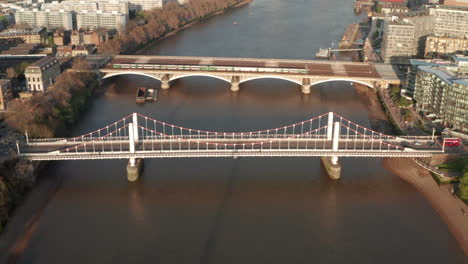 dolly back aerial shot over chelsea and grosvenor bridges