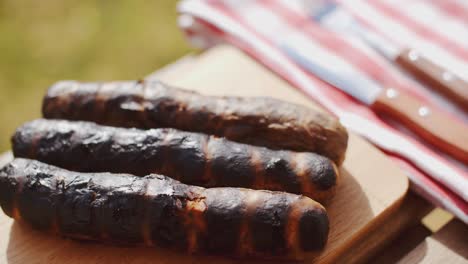 three charred sausages outside