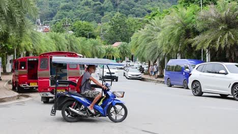 motorbike vendor navigating busy krabi street