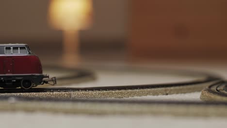 Model-train-moving-into-the-shot-on-a-track-with-a-blurry-background