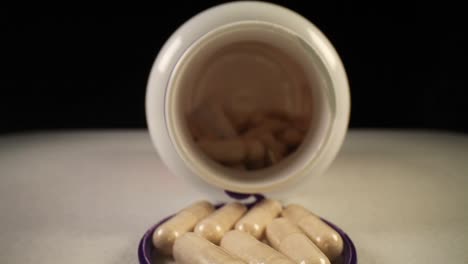 moving past bottle cap, into the entire length of a supplement pill bottle with desiccant still in